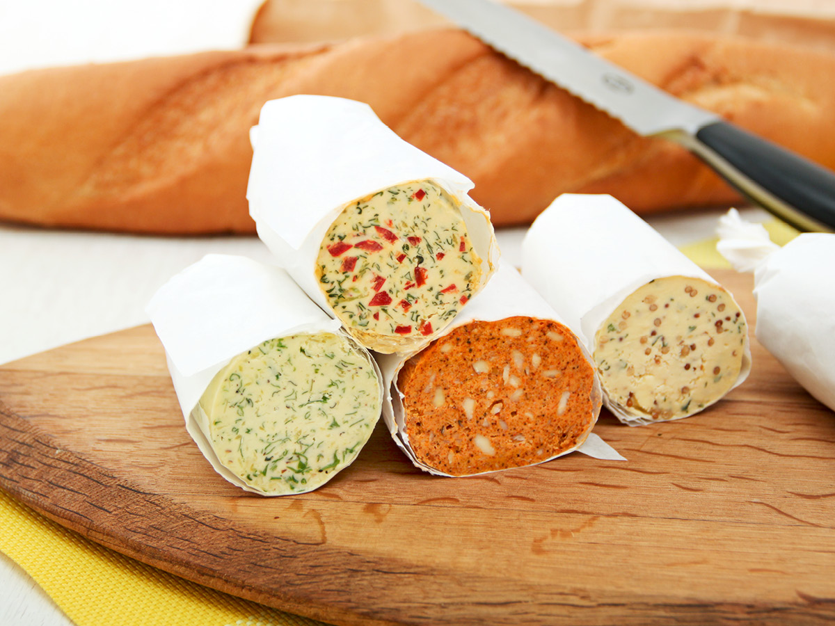 savoury flavoured butters on cutting board
