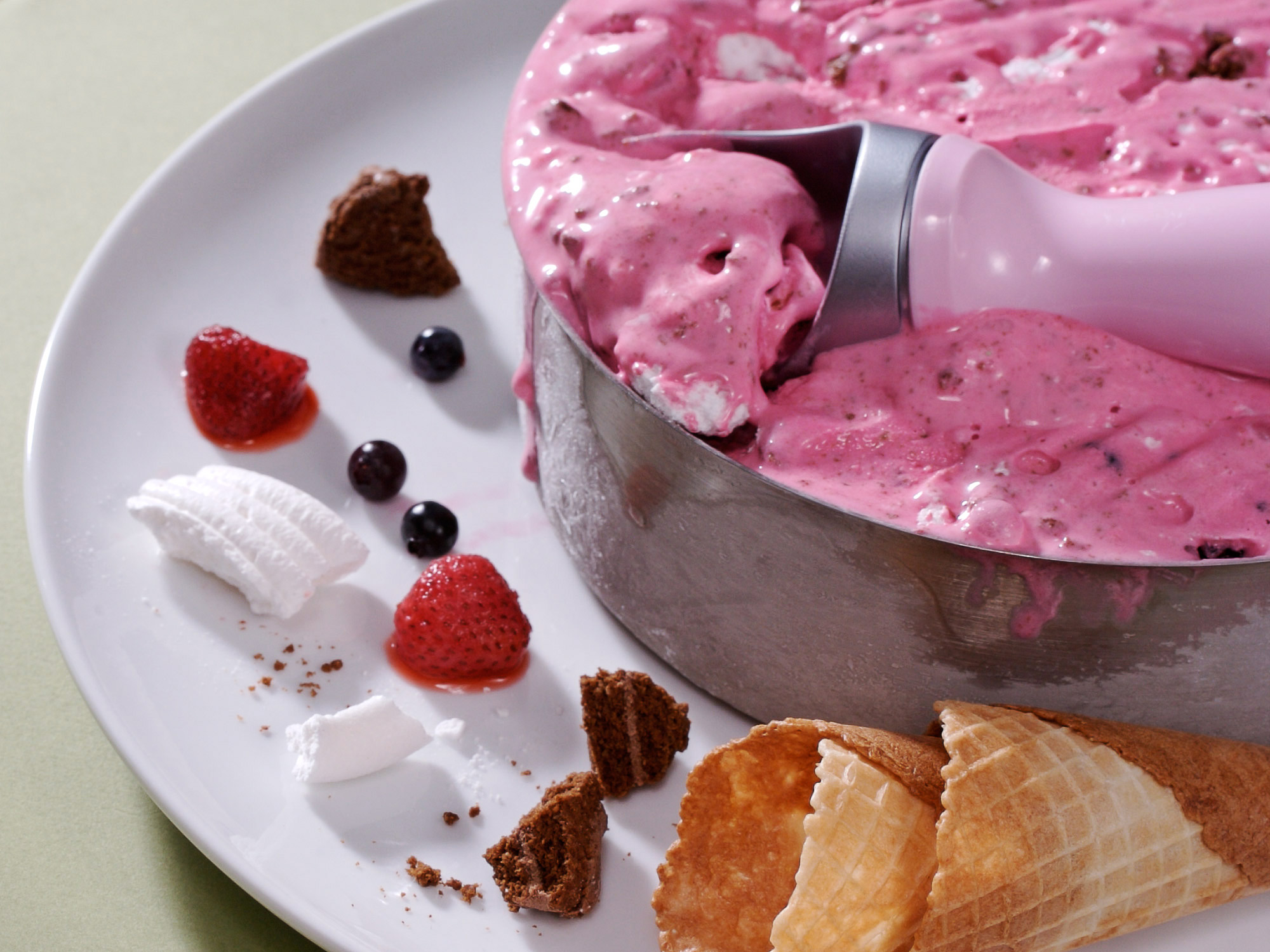 Scooping Rocky road ice-cream out of an AMC cake tin