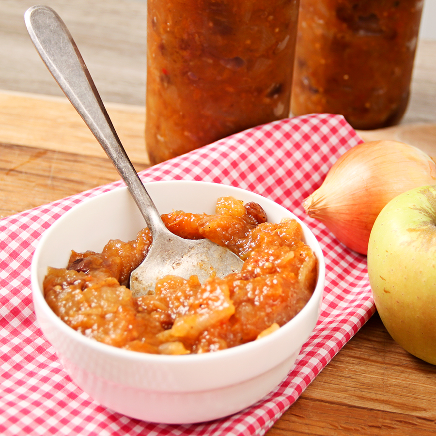 Spicy chutney in white bowl with spoon