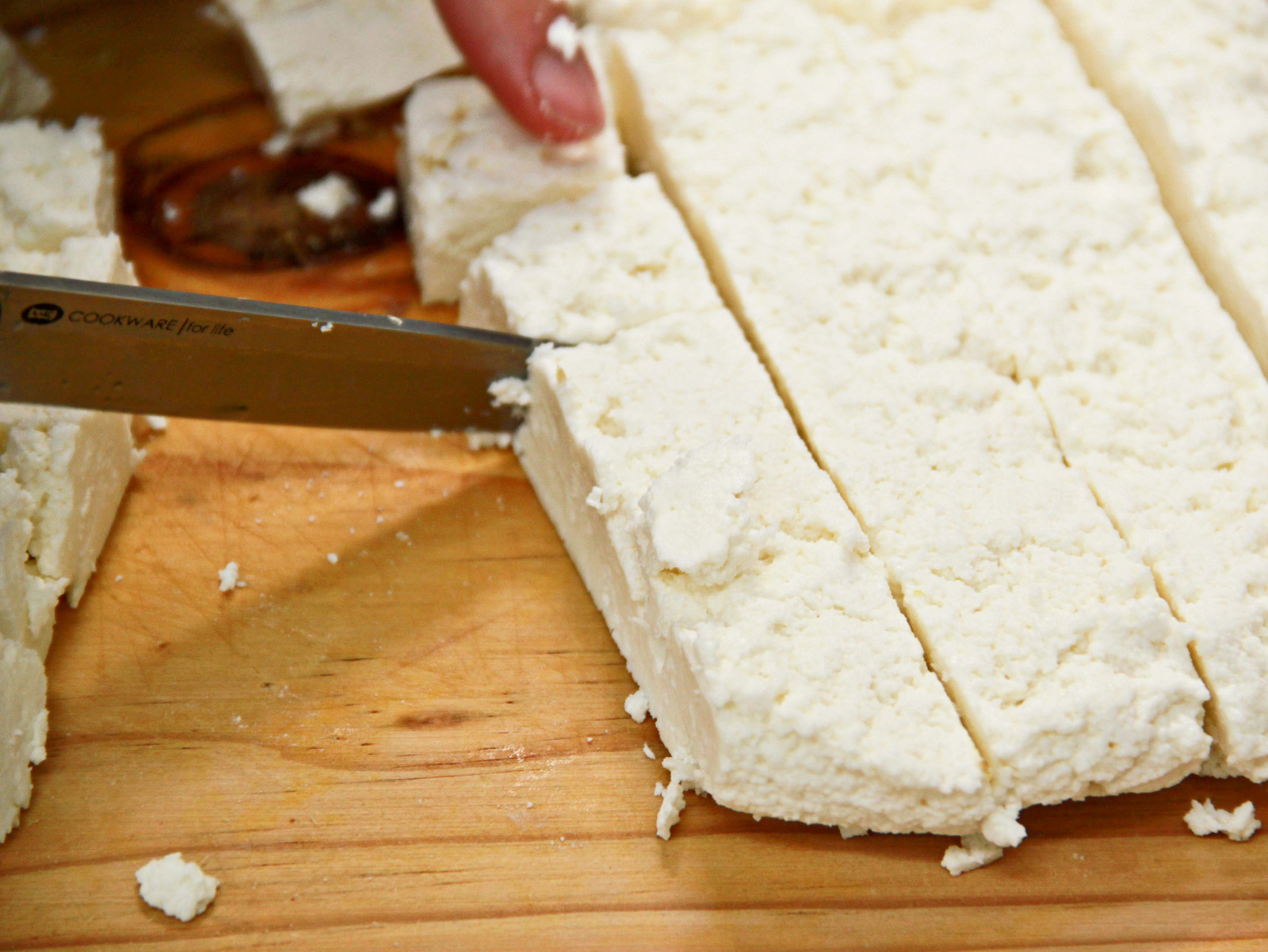 Homemade paneer, being cubed.