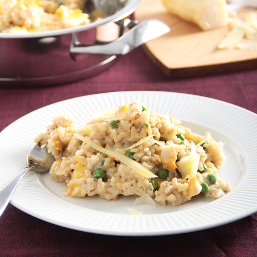 Haddok and pea risotto on a white plate